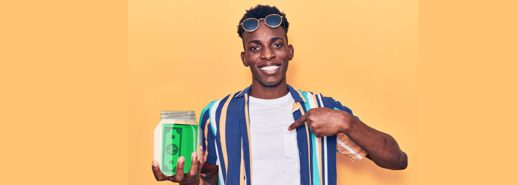 A guy happily holding the jar of money he saved after paying off his loans and avoiding late fees