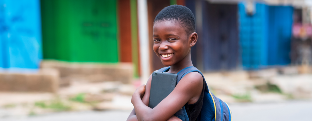 A young and happy school girl whose school fees has just been paid with a loan