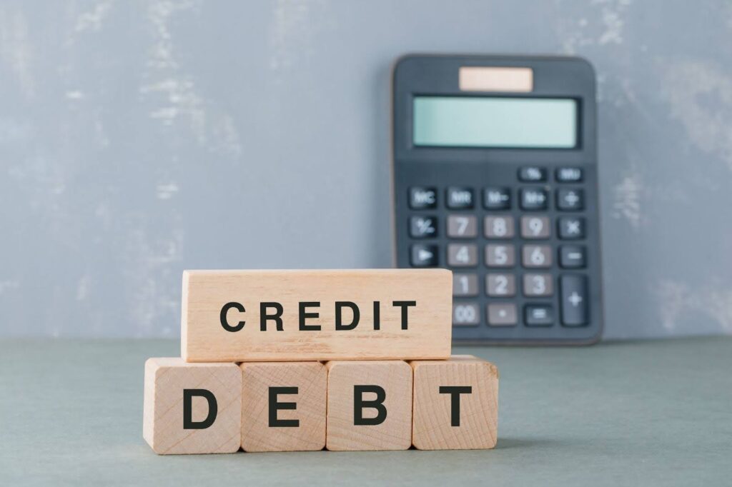 Wooden blocks with credit and debt written on it